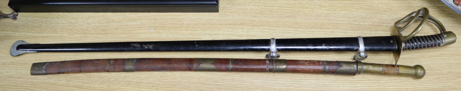 A French Cuirassier sword, blade 93cm, together with an Eastern brass mounted sword with wooden scabbard